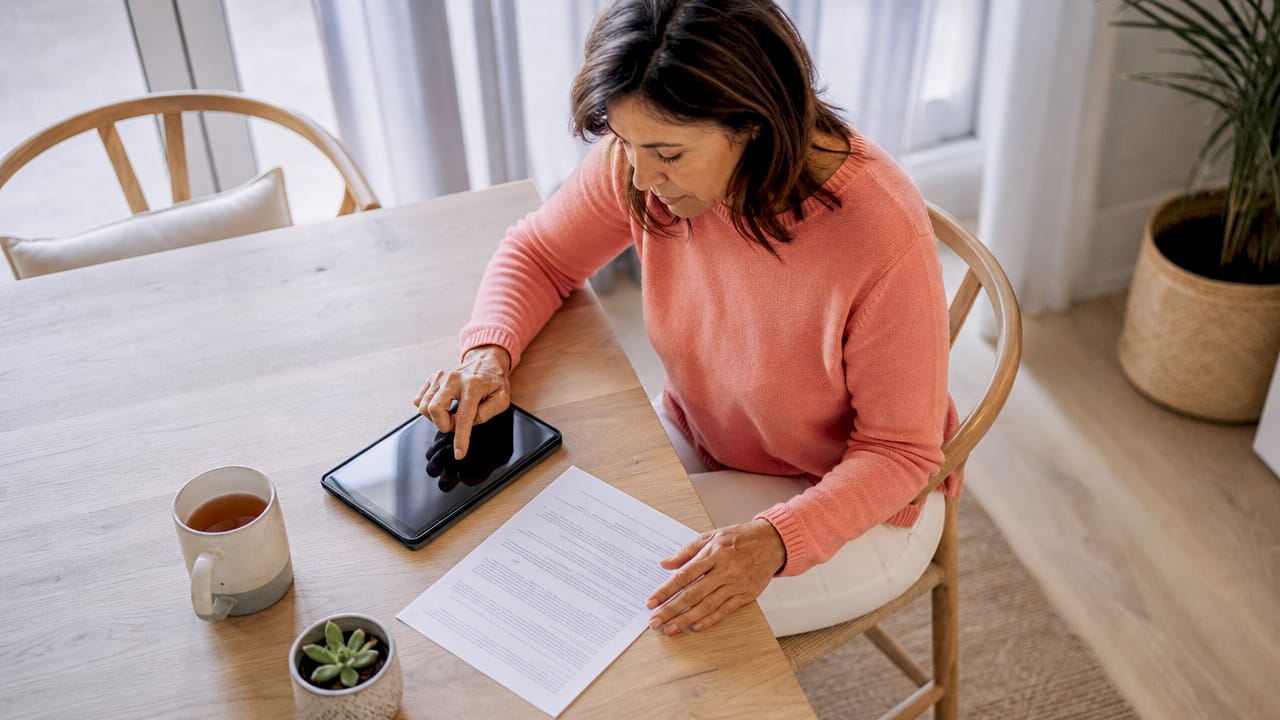 Owner reviewing lease contract at kitchen table