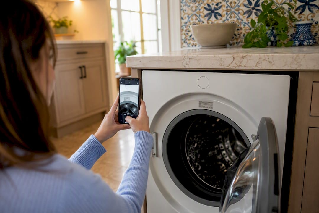 Hand photographing serial number on home appliance