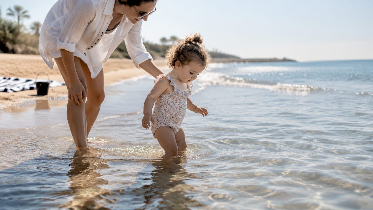Toddler wading in calm shallow Cambrils water